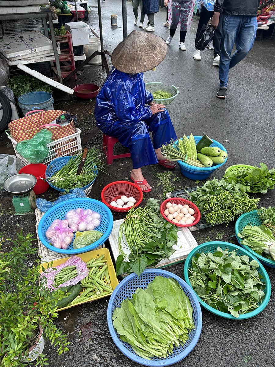 a woman selling vegetables at the street